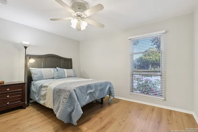 a bedroom with a bed chandelier and a window