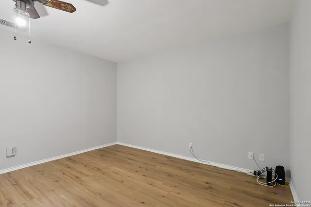 a view of a room with wooden floor