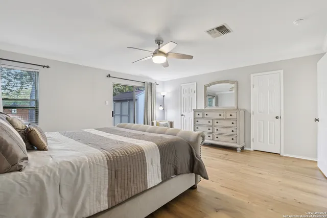 a bedroom with a large bed and a chandelier