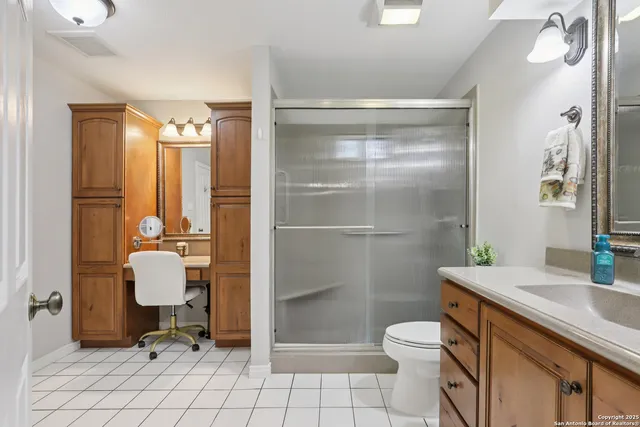 a bathroom with a toilet sink and shower