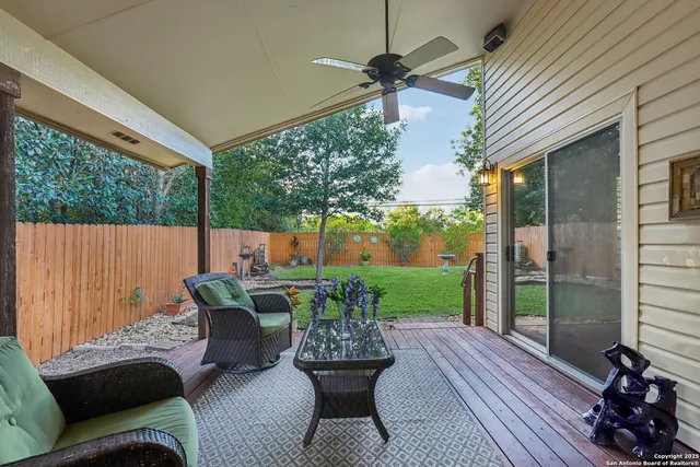 a view of a patio with couches potted plants and a table