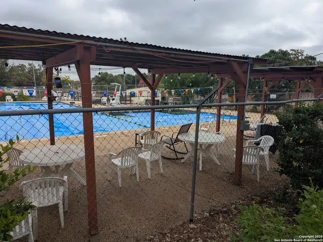 a view of a chairs and table in patio