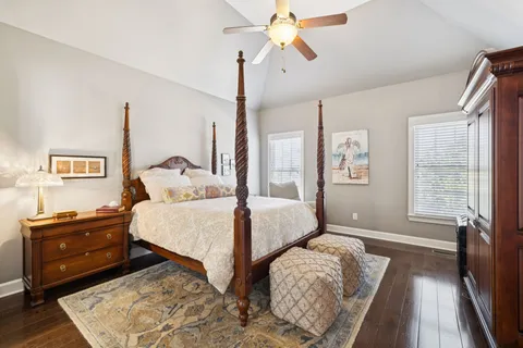 a spacious bedroom with two beds and a chandelier