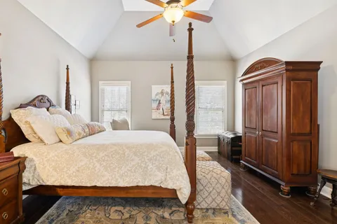 a bedroom with a bed dresser and a window