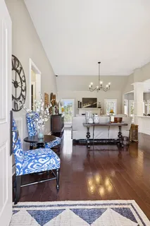 a living room with furniture and kitchen view
