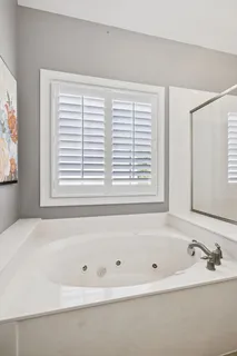 a white bath tub sitting next to a window