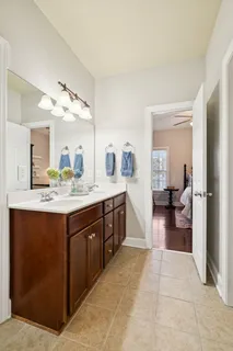 a spacious bathroom with a sink a mirror and a bathtub