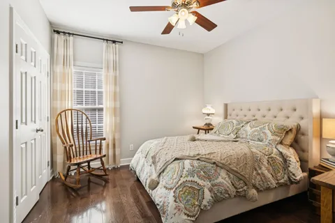 a bedroom with a bed and wooden floor