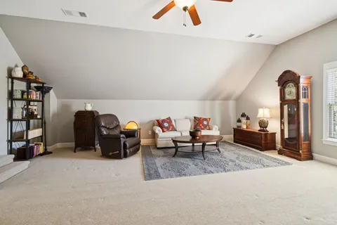 a living room with furniture and a gym machine