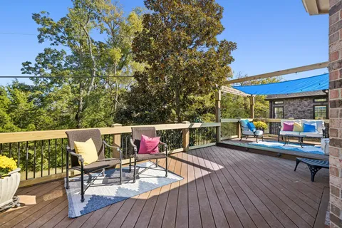 an outdoor sitting area with furniture and wooden floor