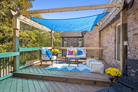 a view of a deck with chairs and wooden floor