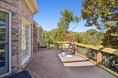 a roof deck with wooden floor and fence