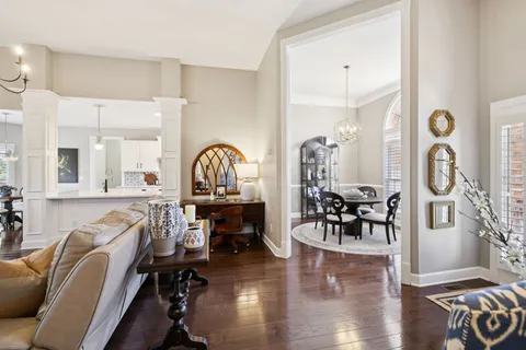 a view of a a dining room with furniture window and wooden floor