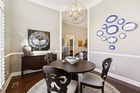 a view of a dining room with furniture and chandelier