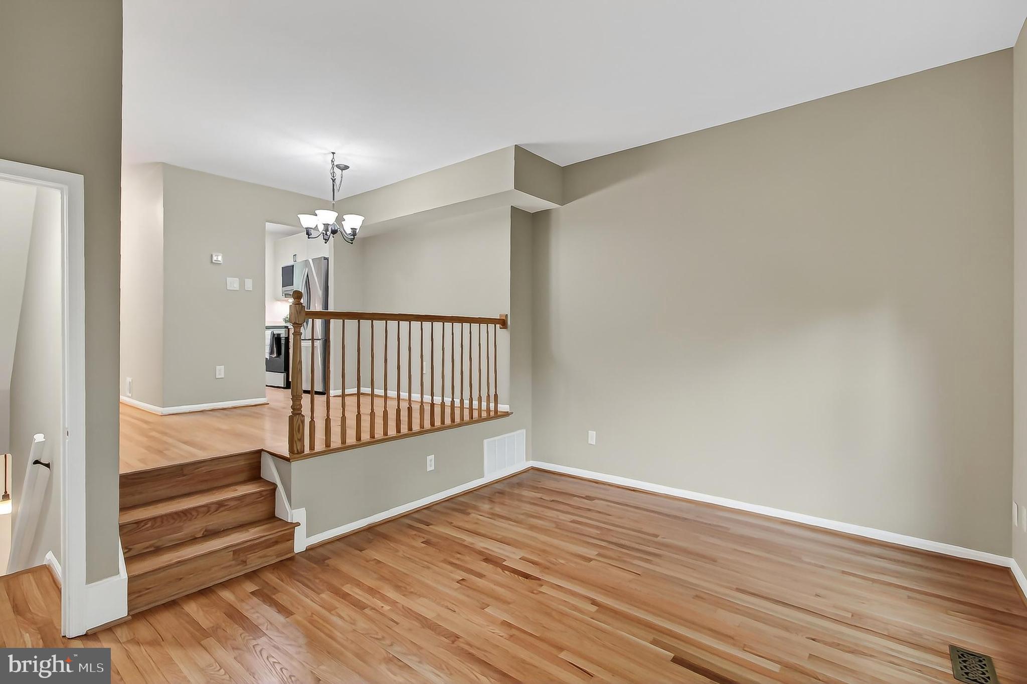 5833 Royal Ridge Drive, Unit 943 Springfield, VA 22152 - Photo 11 of 45 wooden floor in an empty room