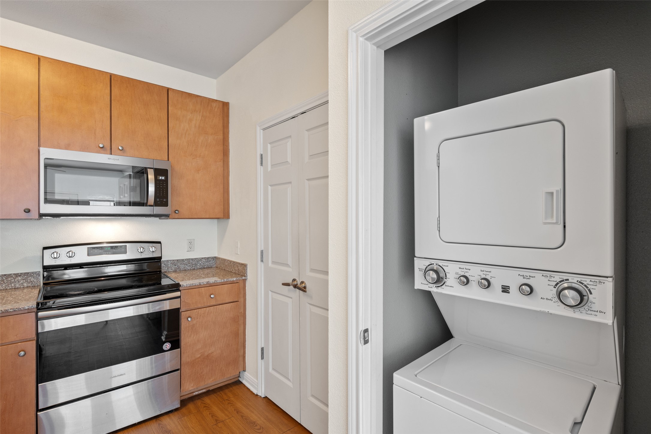 2502 Leon Street, Unit 417 Austin, TX 78705 - Photo 10 of 26 a view of washer and dryer with kitchen in the background