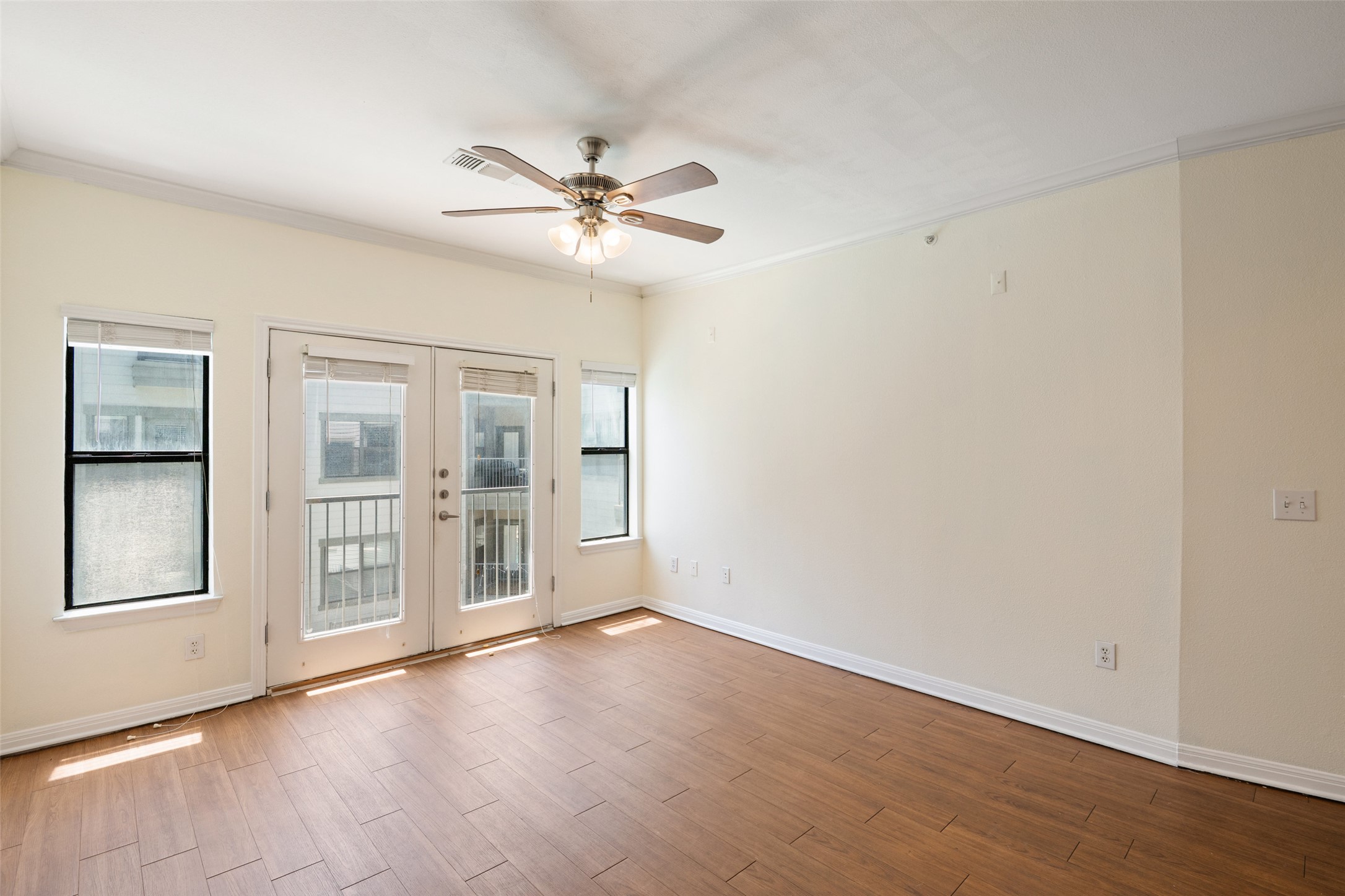 2502 Leon Street, Unit 417 Austin, TX 78705 - Photo 11 of 26 a view of an empty room with a window and wooden floor