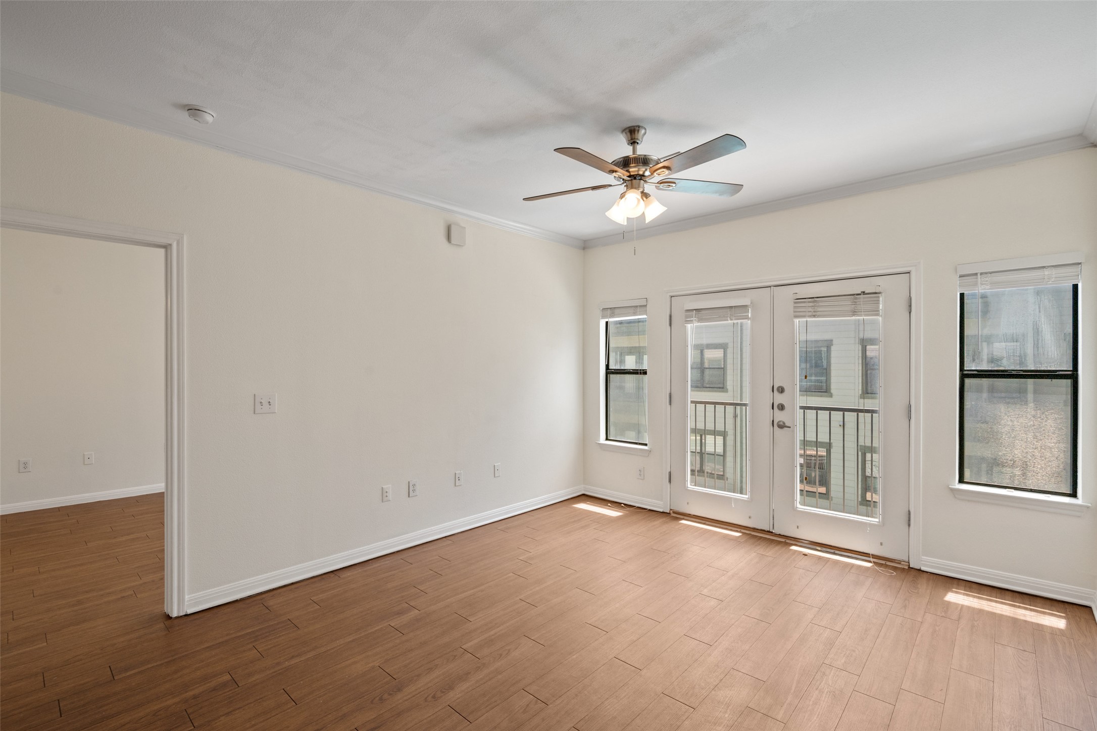 2502 Leon Street, Unit 417 Austin, TX 78705 - Photo 12 of 26 a view of an empty room with a window and wooden floor