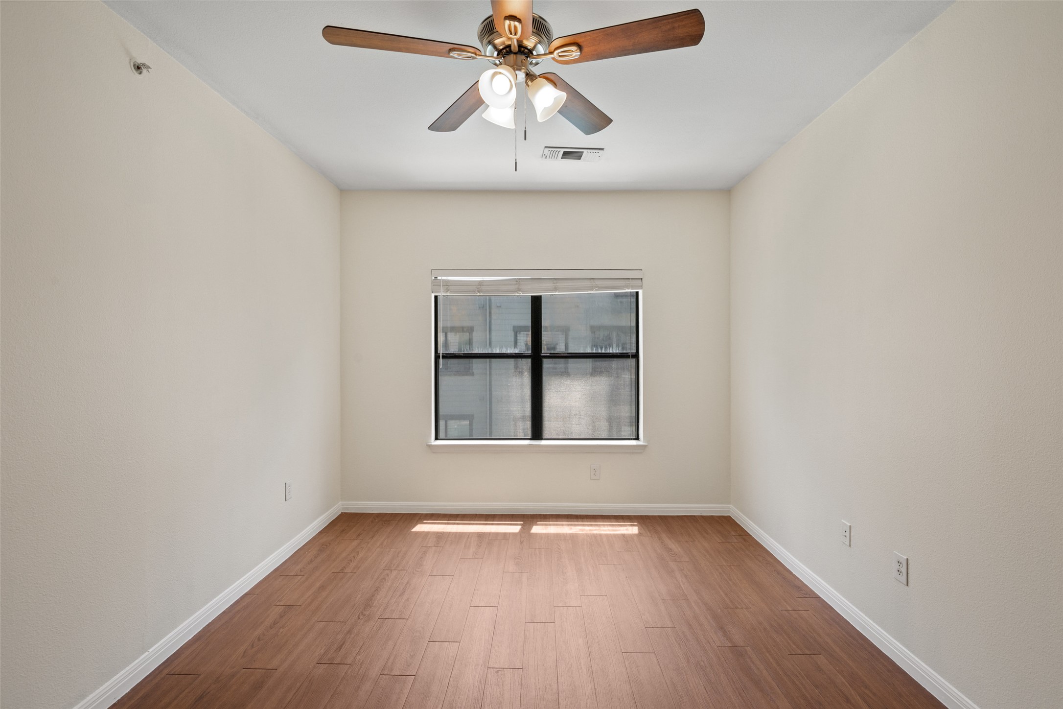2502 Leon Street, Unit 417 Austin, TX 78705 - Photo 17 of 26 an empty room with a window and wooden floor