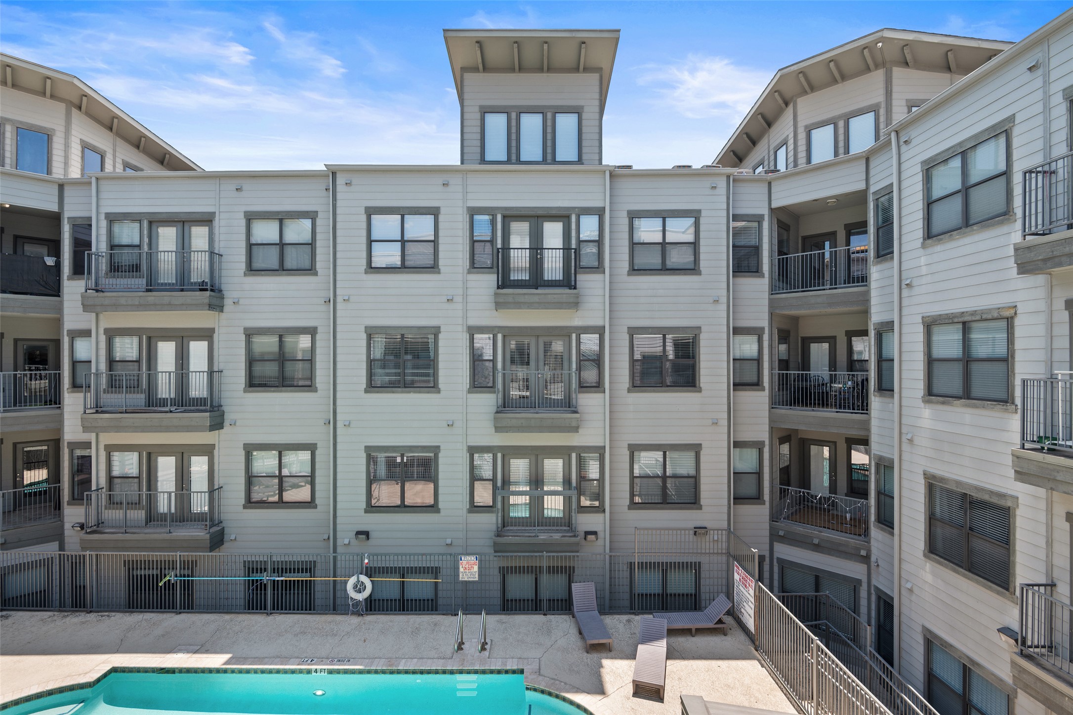 2502 Leon Street, Unit 417 Austin, TX 78705 - Photo 22 of 26 a front view of a building with glass windows and entryway