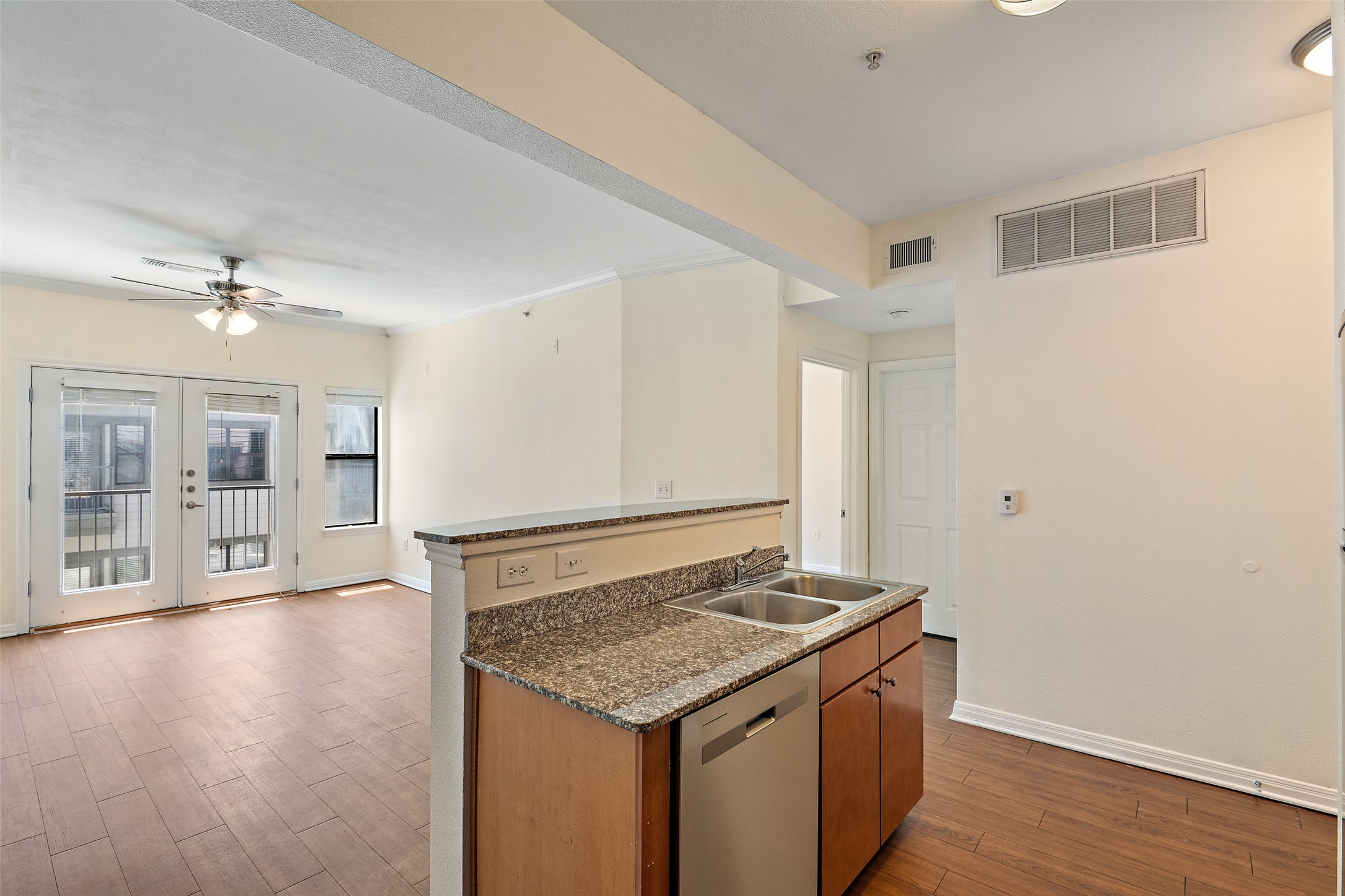 2502 Leon Street, Unit 417 Austin, TX 78705 - Photo 26 of 26 a view of an empty room with wooden floor and a ceiling fan