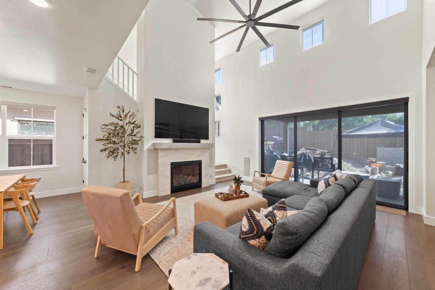 8465 Serene View Road Granite Bay, CA 95746 - Photo 11 of 70 a living room with furniture a flat screen tv and a large window