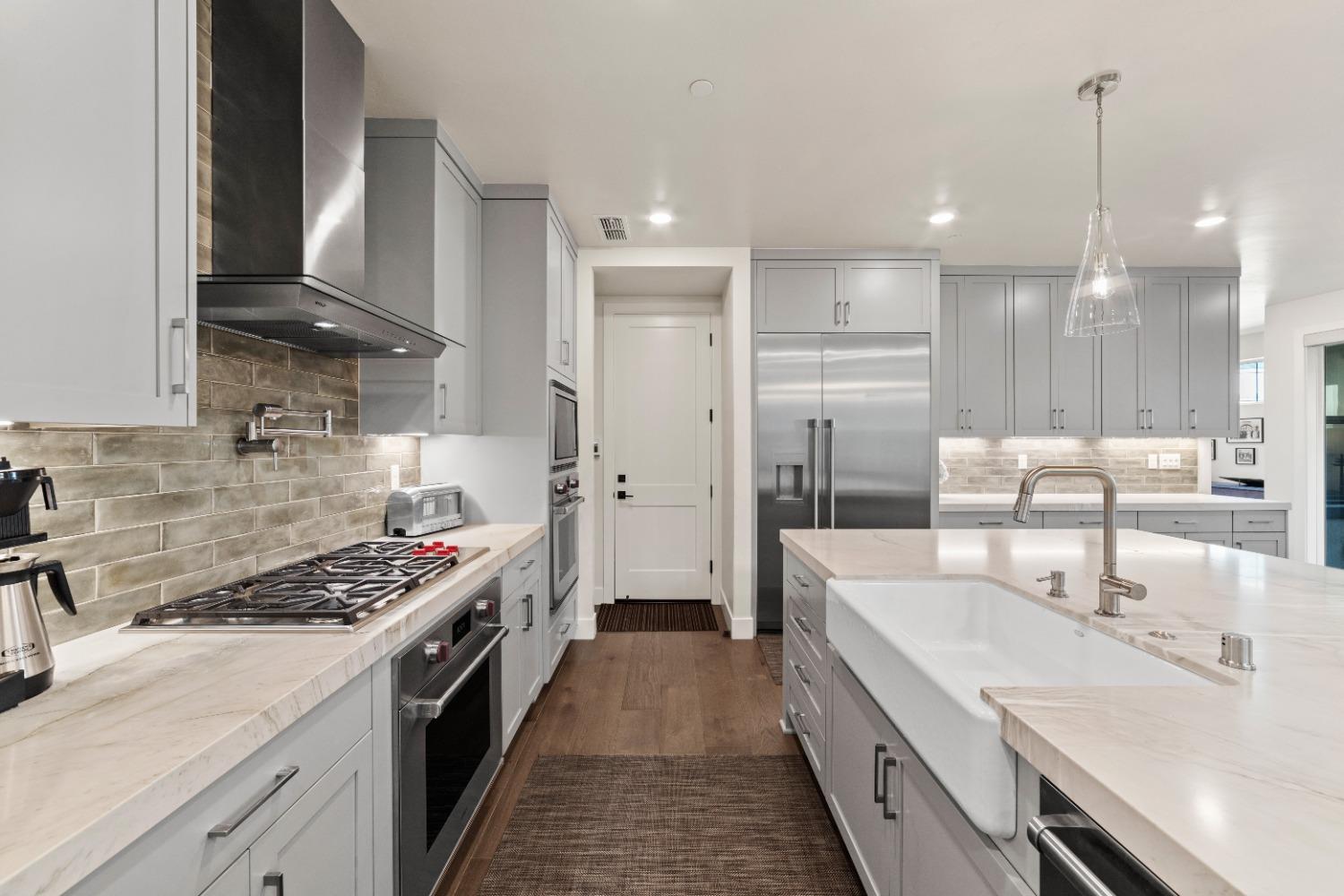 8465 Serene View Road Granite Bay, CA 95746 - Photo 14 of 70 a kitchen with a sink stove and refrigerator