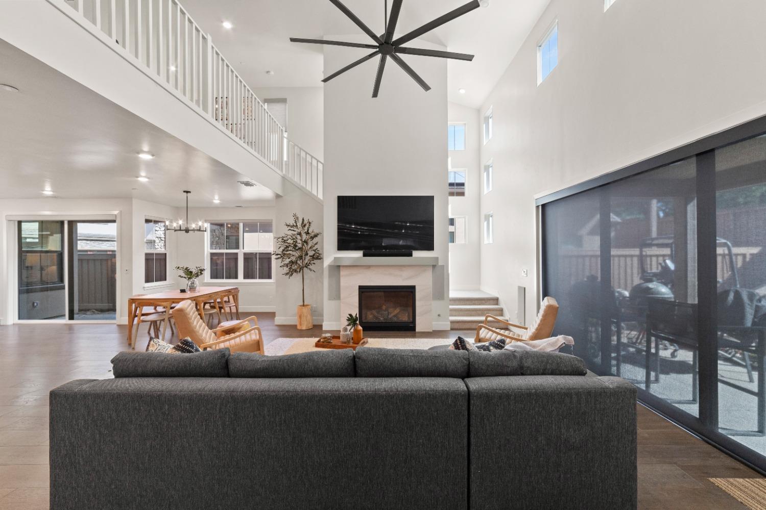 8465 Serene View Road Granite Bay, CA 95746 - Photo 16 of 70 a living room with fireplace furniture and a flat screen tv