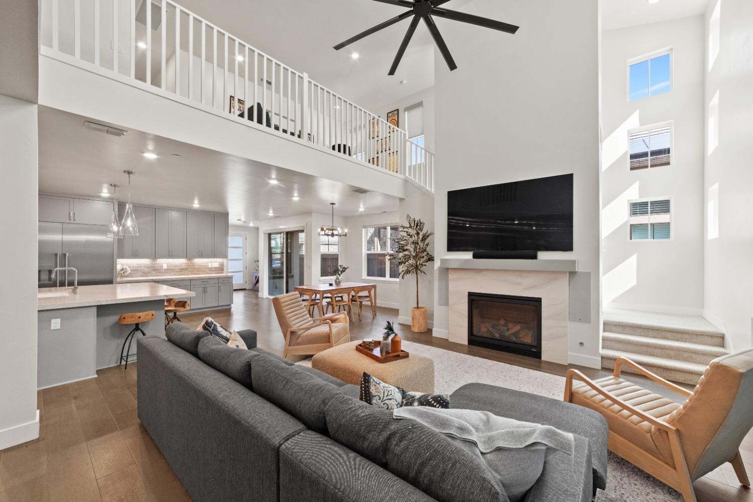 8465 Serene View Road Granite Bay, CA 95746 - Photo 17 of 70 a living room with furniture a fireplace and a flat screen tv