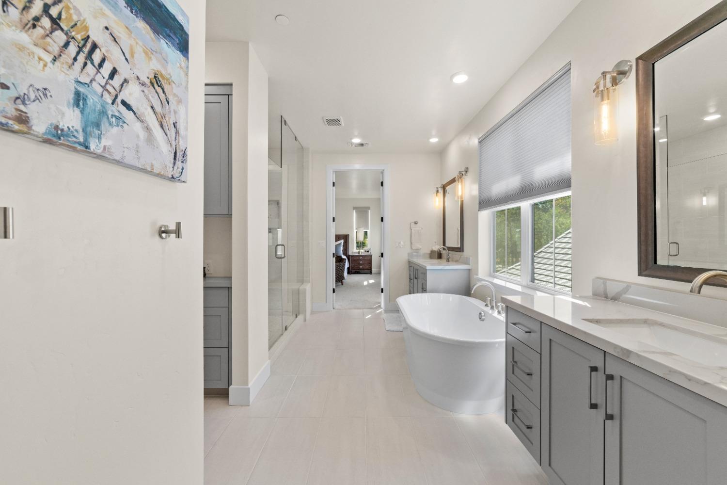 8465 Serene View Road Granite Bay, CA 95746 - Photo 41 of 70 a spacious bathroom with a granite countertop sink and a mirror