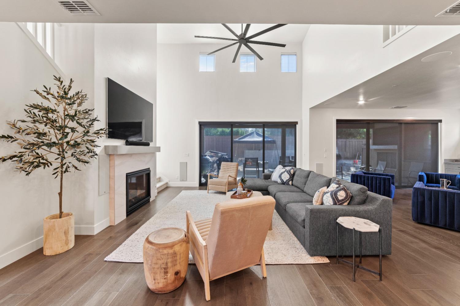 8465 Serene View Road Granite Bay, CA 95746 - Photo 10 of 70 a living room with furniture a fireplace and a flat screen tv
