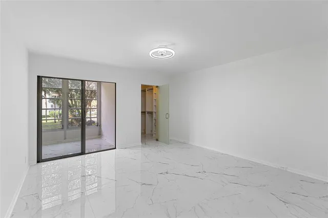 an empty room with sliding glass door