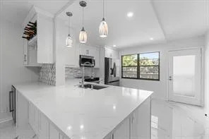 a kitchen with a stove a refrigerator and furniture