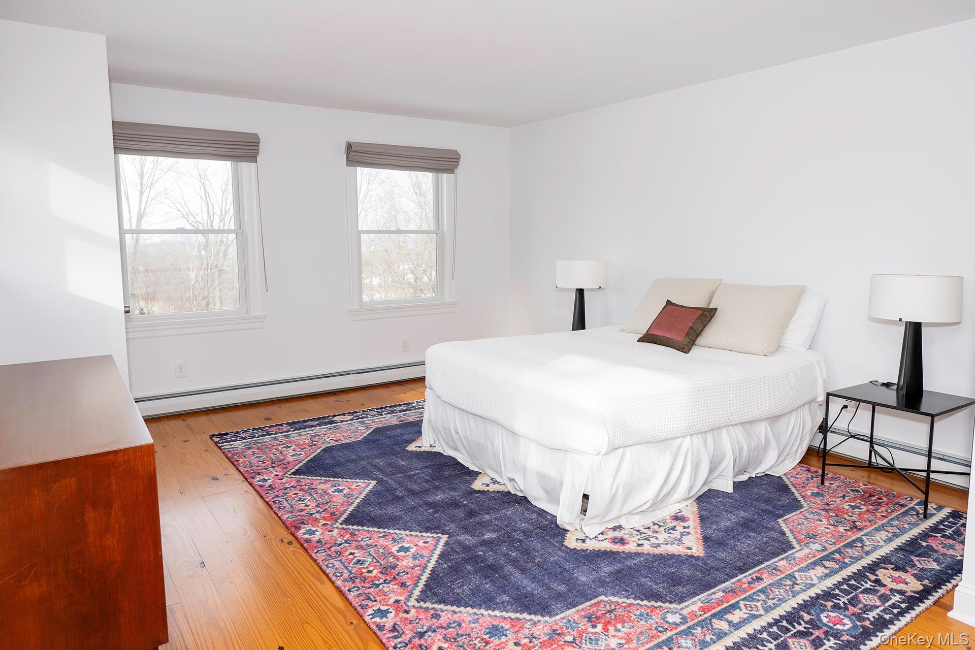 692 Bangall Road Millbrook, NY 12545 - Photo 18 of 30 a bedroom with a bed and a lamp on dresser
