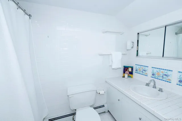 a bathroom with a granite countertop shower mirror and a sink