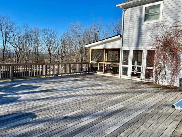 a view of backyard with deck and trees