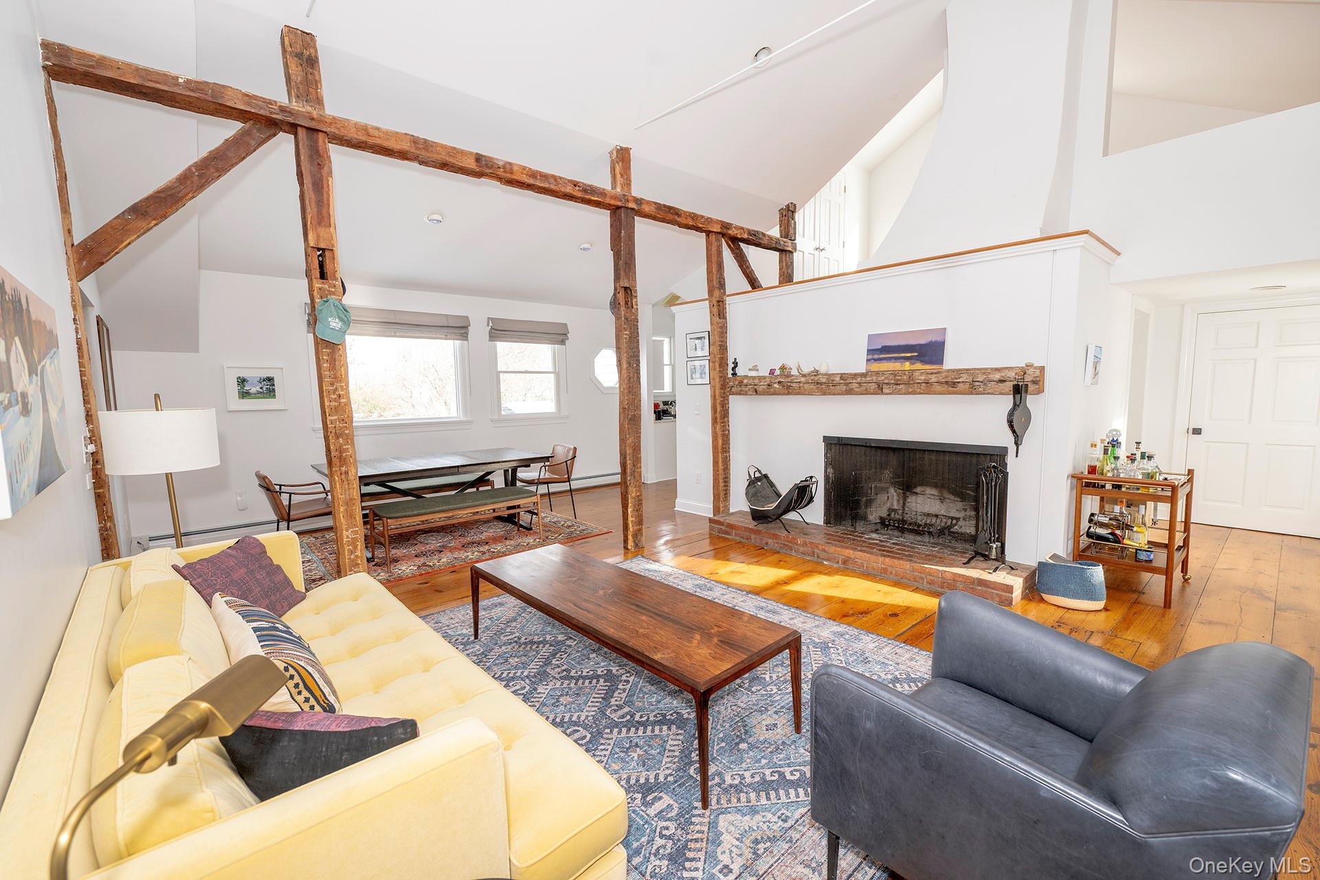 692 Bangall Road Millbrook, NY 12545 - Photo 10 of 30 a living room with furniture a fireplace and a table
