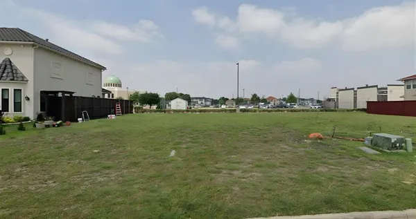 a view of a terrace with chairs and garden