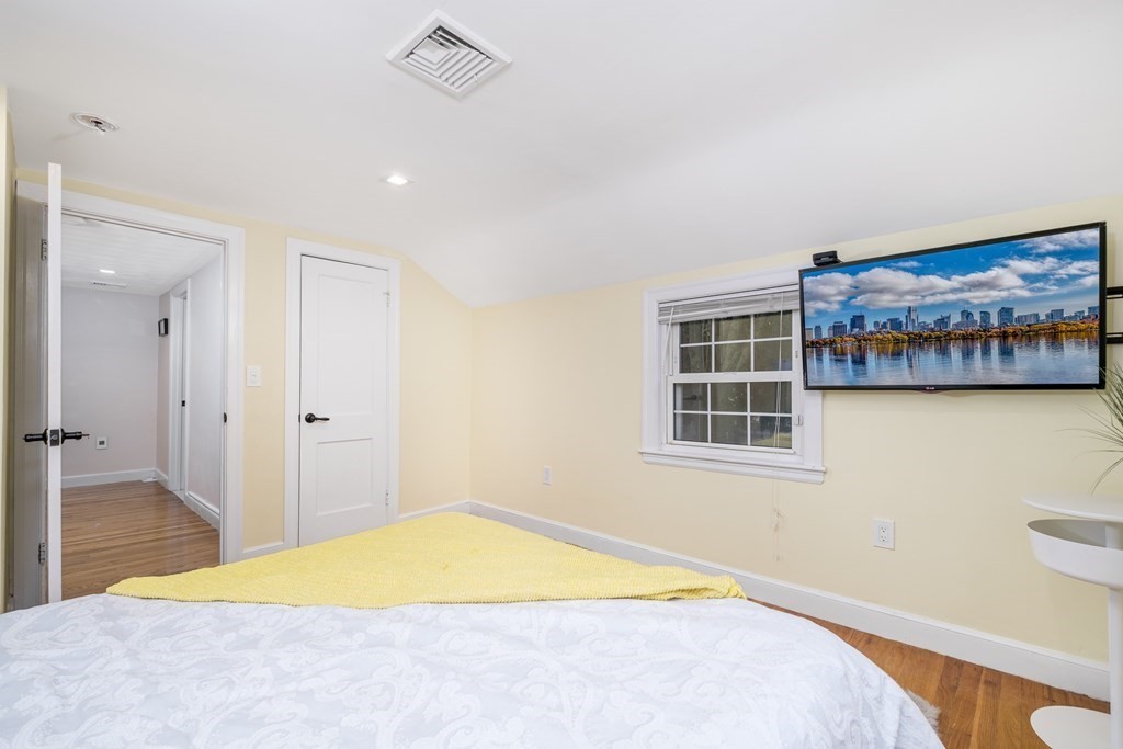 32 Tufts Road Winchester, MA 01890 - Photo 13 of 24 a bedroom with a bed and a painting on the wall