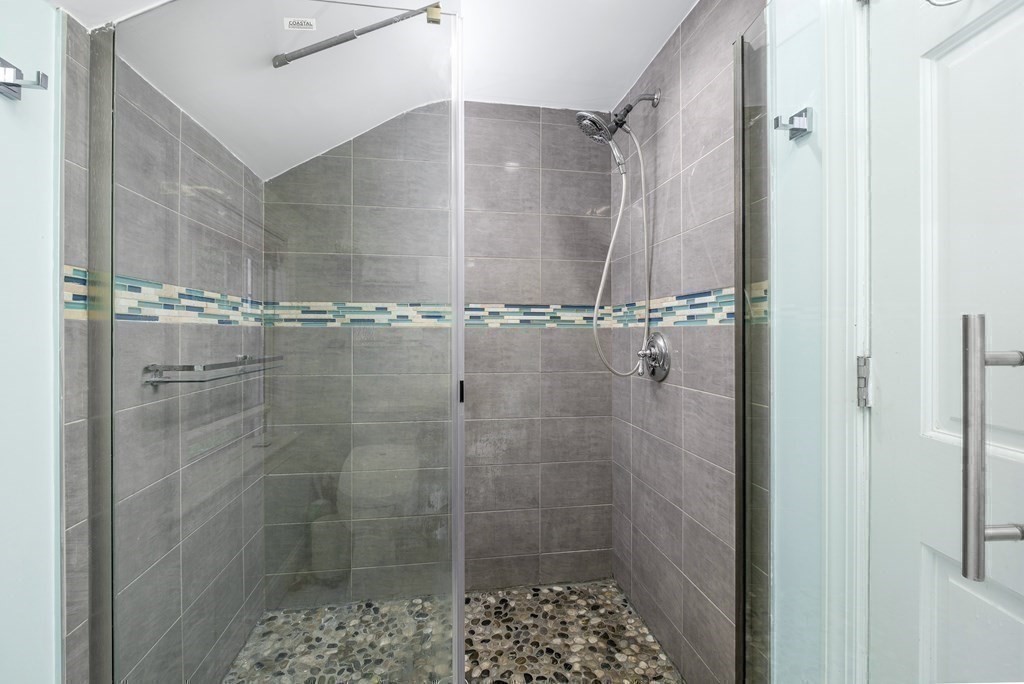 32 Tufts Road Winchester, MA 01890 - Photo 15 of 24 a bathroom with a glass shower door