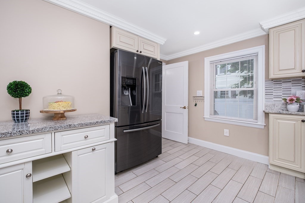32 Tufts Road Winchester, MA 01890 - Photo 5 of 24 a kitchen with granite countertop a refrigerator and cabinets