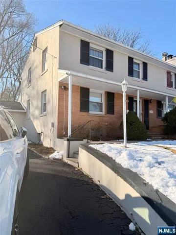 a view of a house with snow on the road