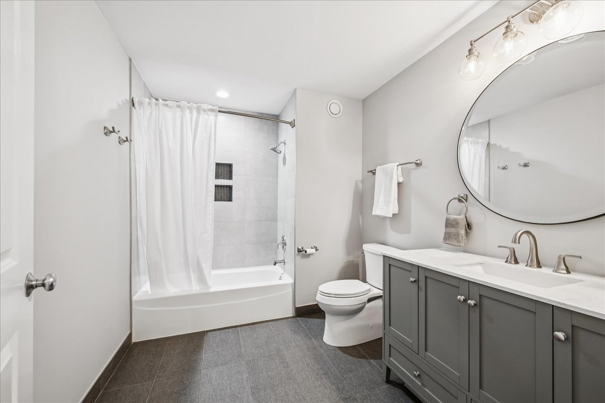 230 West Division Street, Unit 1202 Chicago, IL 60610 - Photo 16 of 20 a bathroom with a toilet sink and mirror