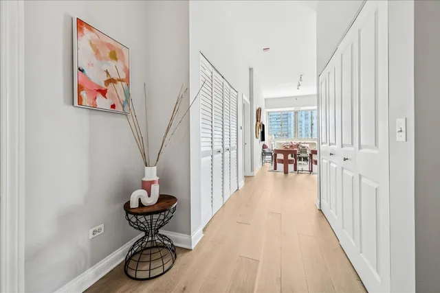 a view of entryway and hall with wooden floor