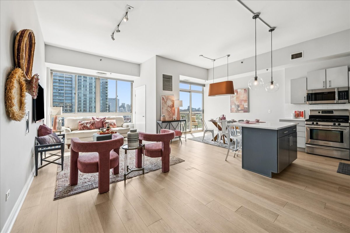 230 West Division Street, Unit 1202 Chicago, IL 60610 - Photo 3 of 20 a living room with stainless steel appliances kitchen island granite countertop furniture and a kitchen view