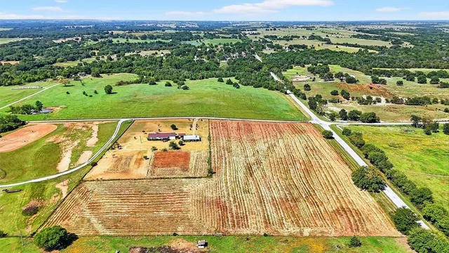 an aerial view of a swimming pool with a yard