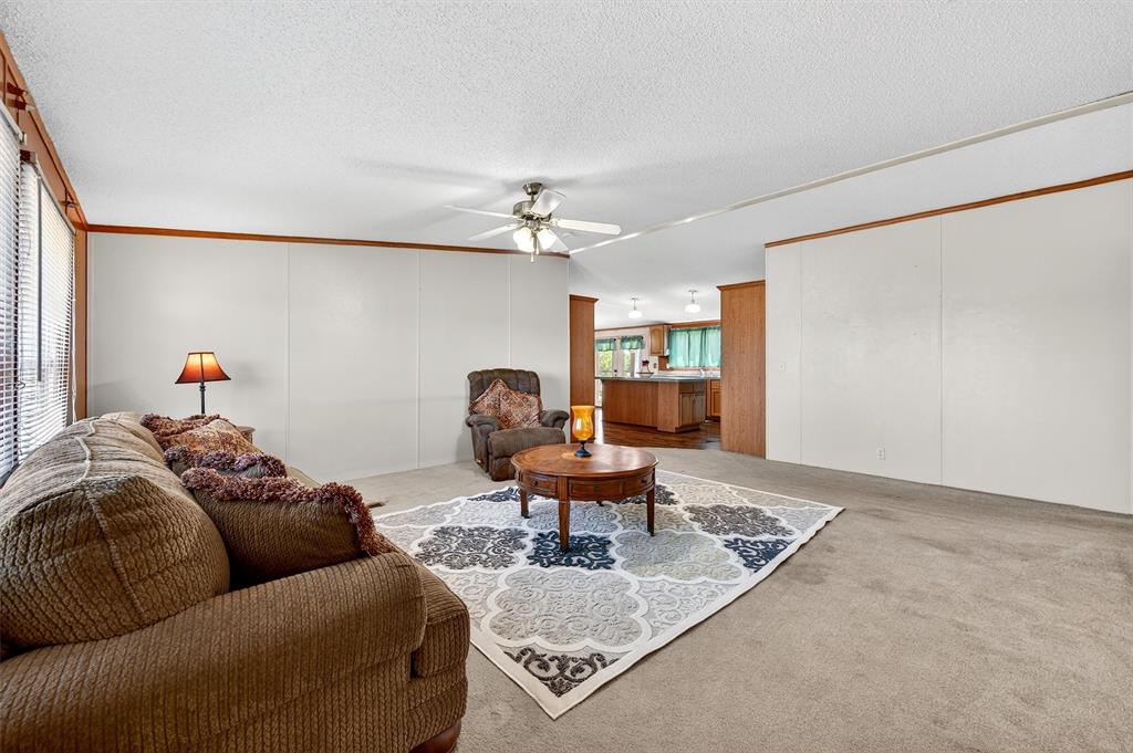 12085 Keys Road Marietta, OK 73448 - Photo 25 of 40 a living room with furniture and a chandelier