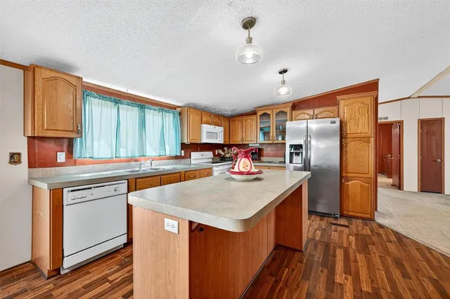a kitchen with stainless steel appliances granite countertop a stove and a refrigerator