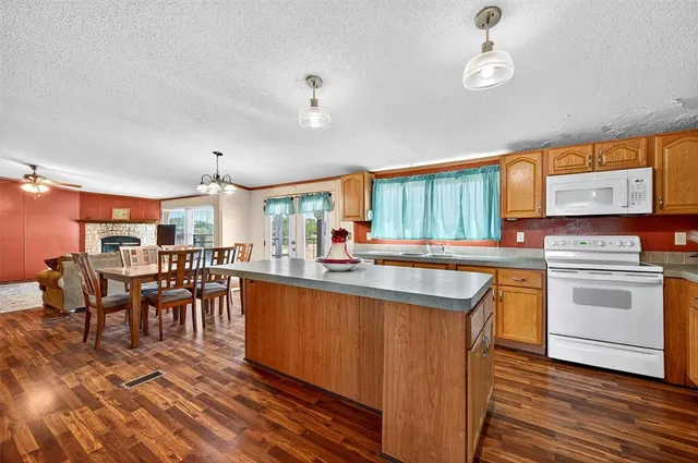 a kitchen with sink refrigerator and cabinets