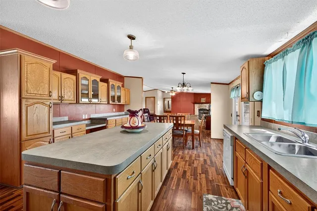 a dining room with furniture a chandelier and wooden floor